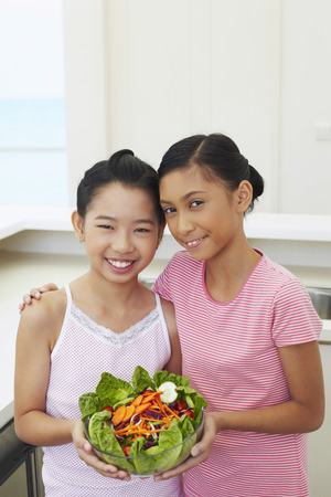 Girls with a bowl of saladの写真素材