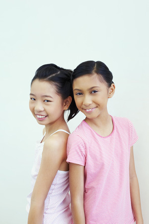 Girls with back facing each otherの写真素材