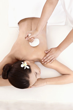 Woman enjoying herbal compress treatmentの写真素材