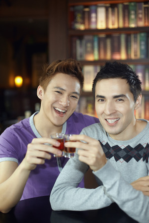 Men toasting drinksの写真素材