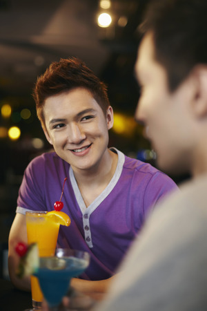 Friends chatting and drinkingの写真素材