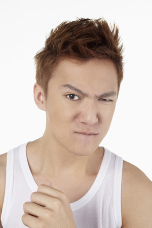 Man frowning and looking at the cameraの写真素材