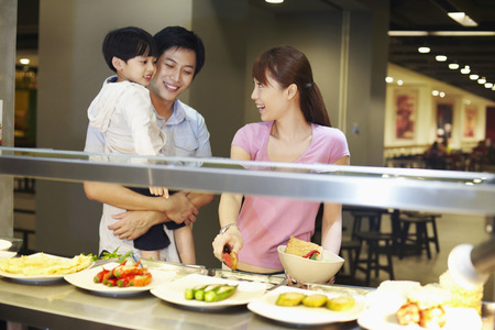 Family choosing food at the food courtの写真素材