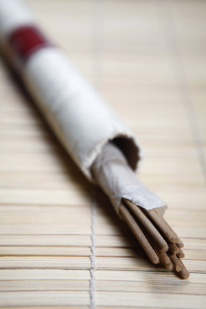 Joss sticks placed on a wooden matの写真素材