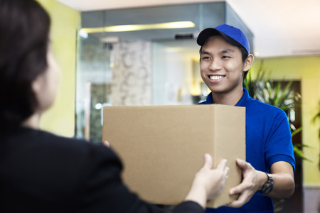 Postal worker delivering a packageの写真素材
