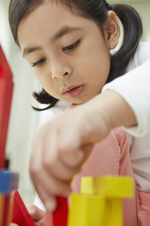 Girl playing with colorful building blocksの写真素材