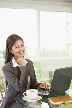 Cheerful businesswoman working on the laptopの写真素材