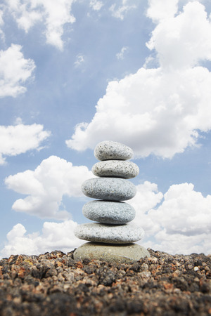 View of stacked up pebbles against clear skyの写真素材