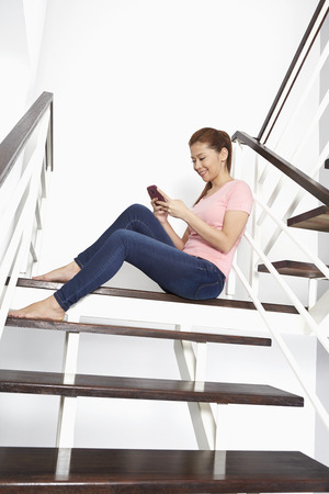 Cheerful woman text messagingの写真素材