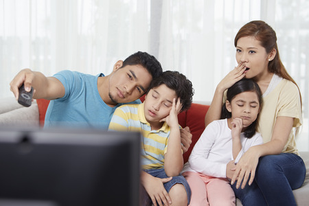 Parents and children watching televisionの写真素材