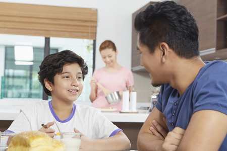 Father and son having breakfast togetherの写真素材