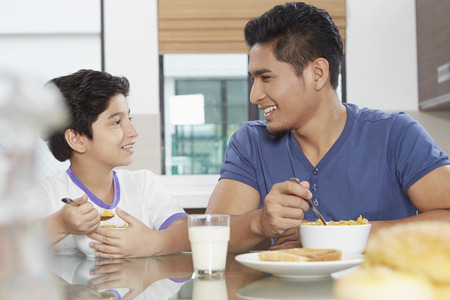 Father and son eating cerealsの写真素材
