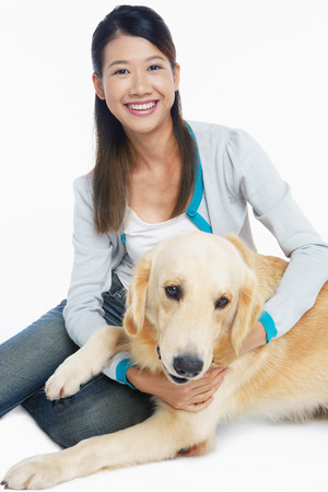 A dog pet with a young woman ownerの写真素材