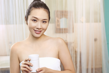 A young woman holding a mugの写真素材