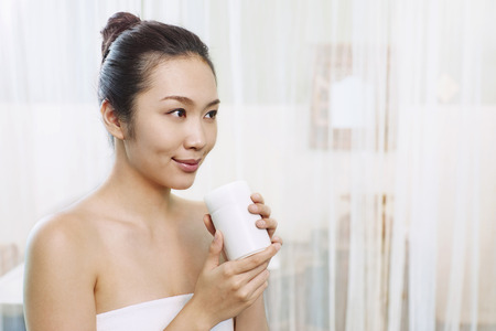 A young woman holding a mugの写真素材