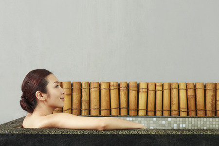 A young woman taking a bathの写真素材