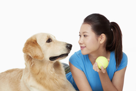 A dog pet with a young woman ownerの写真素材