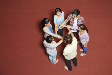 Students having a team huddleの写真素材