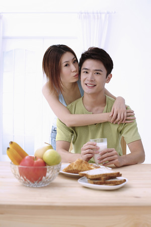 Woman about to give man a kissの写真素材
