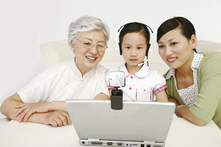Girl video conferencing, senior woman and woman watching