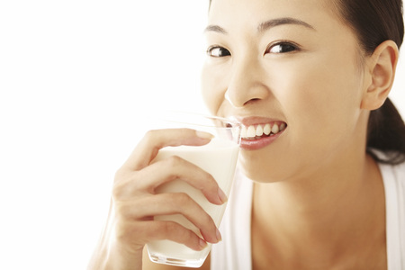 Woman with a glass of milkの写真素材