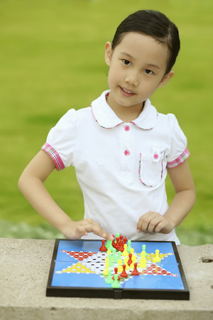 Girl playing chinese checkersの写真素材