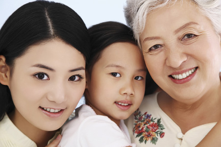 Woman, girl and senior woman posing for the cameraの写真素材