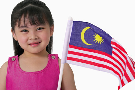 Young Chinese girl holding Malaysian flagの写真素材