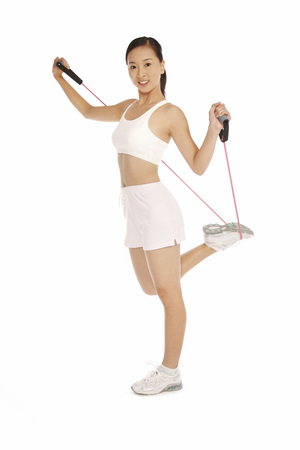 Young woman exercising with resistance bandの写真素材