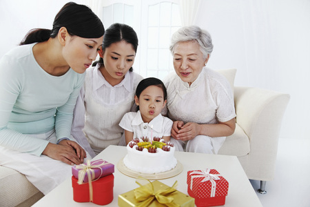 Women celebrating girl's birthday