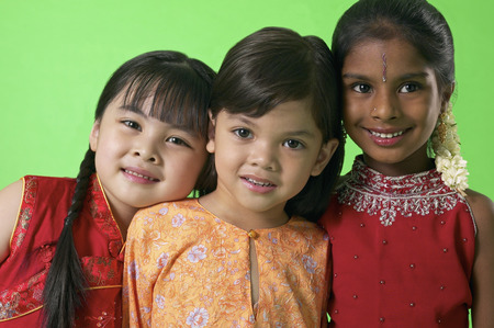 Young Malay, Chinese and Indian girls in traditional clothesの写真素材
