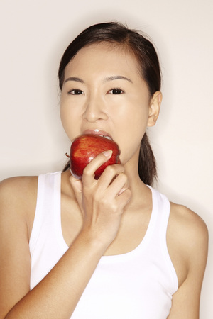 Woman eating an appleの写真素材