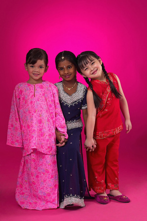 Young Malay, Chinese and Indian girls in traditional clothesの写真素材