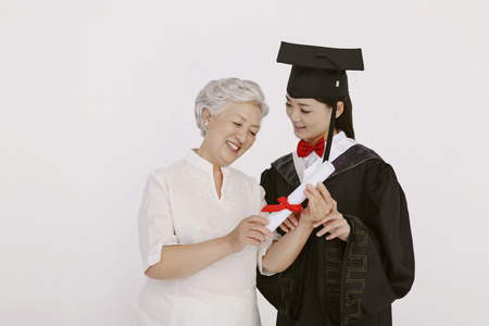 Senior woman looking graduate's scrollの写真素材