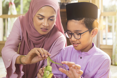 Muslim family weaving ketupatの写真素材