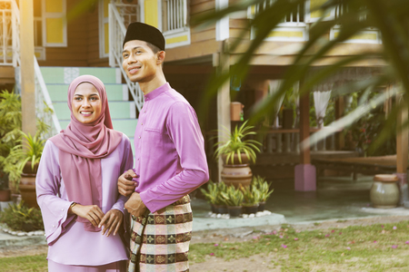 Muslim family standing outside their houseの写真素材