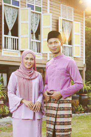 Muslim family standing outside their houseの写真素材