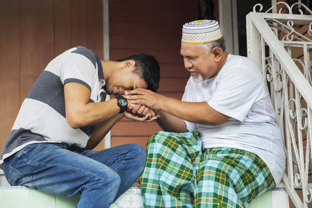 Man greeting his father with handshakeの写真素材