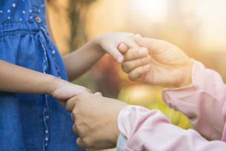 Girl holding hands with her grandmother