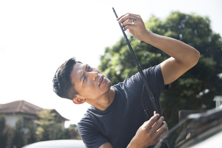 Man checking windshield wiper of his carの写真素材