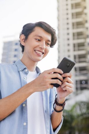 Young man using a smartphoneの写真素材
