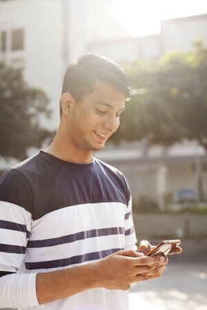 Young man texting on the phoneの写真素材