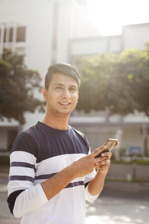 Young man with a mobile phoneの写真素材