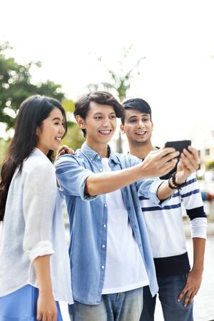 Group of friends taking a selfie togetherの写真素材