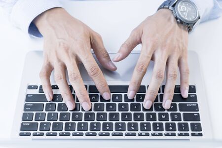 Man typing on laptop