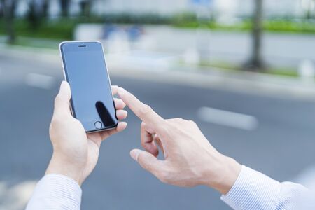 Man using mobile phone outdoorsの写真素材