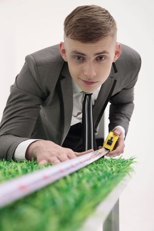 Man measuring length of tableの写真素材