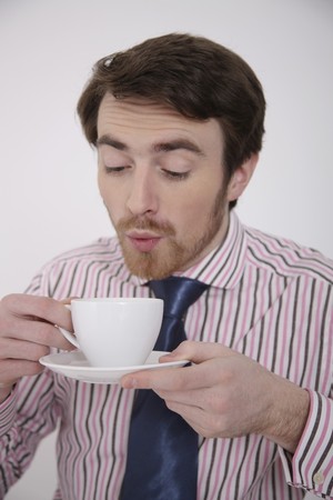 Man holding a cup of coffeeの写真素材