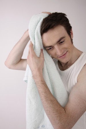 Man wiping his hair with towelの写真素材