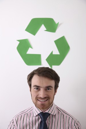 Man smiling with recyling symbol above his headの写真素材